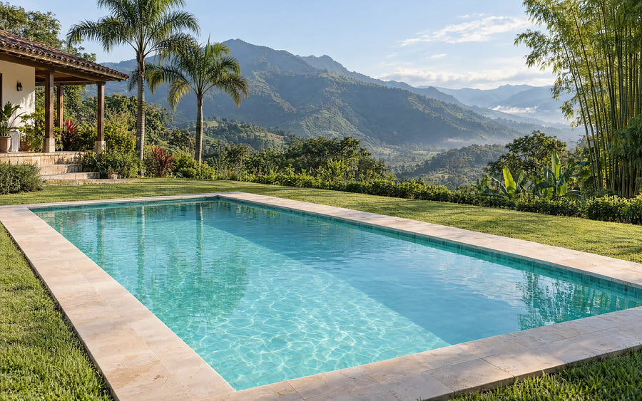 Piscina de finca con agua cristalina y montañas verdes al fondo